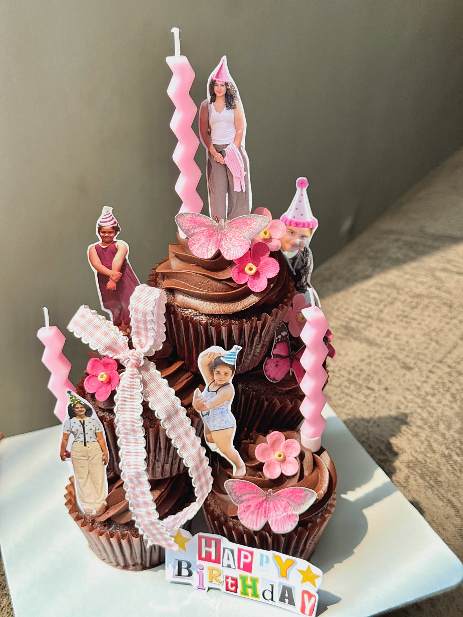Pink cupcake tower with bows and candles